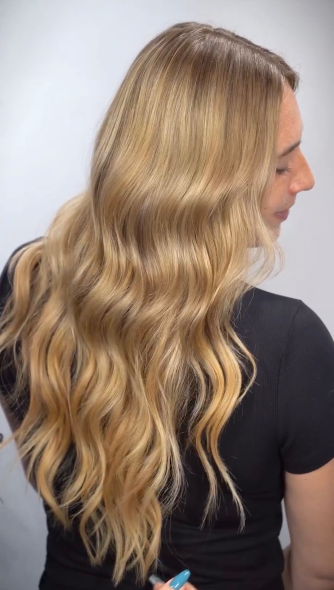 Glossy honey-blonde waves finished at the chair